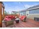Inviting deck features comfortable seating, a modern fire pit, and stylish string lights for outdoor gatherings at 7903 E 50Th Dr, Denver, CO 80238