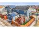 Backyard aerial view featuring a spacious deck, artificial turf, and a wood fence providing privacy at 7903 E 50Th Dr, Denver, CO 80238