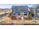 Inviting two-story home with solar panels, a front porch, and professional landscaping at 7903 E 50Th Dr, Denver, CO 80238