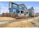 Attractive two-story home with a welcoming front porch and well-maintained front yard at 7903 E 50Th Dr, Denver, CO 80238