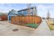 Charming blue two-story home with a privacy fence and manicured landscaping at 7903 E 50Th Dr, Denver, CO 80238