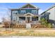 Charming two-story home with a covered front porch and manicured front yard at 7903 E 50Th Dr, Denver, CO 80238