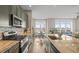 Well-appointed kitchen with stainless steel appliances, modern cabinetry, and a kitchen island with bar seating, offering ample space at 7903 E 50Th Dr, Denver, CO 80238