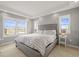 Bright main bedroom with large windows, a comfortable bed, and a tranquil atmosphere for restful nights at 7903 E 50Th Dr, Denver, CO 80238