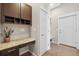 Home office features a granite countertop desk space with cabinets and shelves providing functional and stylish workspace at 7903 E 50Th Dr, Denver, CO 80238