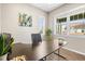 Well-lit office featuring a stylish desk, plants, and bright windows at 7903 E 50Th Dr, Denver, CO 80238
