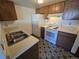 Well-lit kitchen boasts a stainless steel sink, white appliances, and unique patterned flooring at 3100 S Federal Blvd # 213, Denver, CO 80236