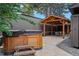 Backyard with wooden hot tub, covered outdoor dining area with stylish wooden arbor and grey gravel detail at 970 S Steele St, Denver, CO 80209