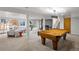 Finished basement with a pool table, fireplace, and comfortable seating areas at 970 S Steele St, Denver, CO 80209
