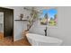 Bathroom featuring a modern soaking tub and a window with a view at 970 S Steele St, Denver, CO 80209