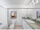 Bathroom with a modern toilet and granite countertop vanity with decorative lighting at 970 S Steele St, Denver, CO 80209