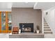 Living room fireplace with stone surround, a mantel, and adjacent staircase adding warmth and charm at 970 S Steele St, Denver, CO 80209