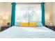 Bright bedroom with teal bedding and yellow pillows at 3200 N Fillmore St, Denver, CO 80205