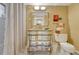 A bathroom features a vanity with mirrored facade, hexagon tiling, and shower with curtain at 861 N Humboldt St # A, Denver, CO 80218