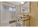 Bathroom features a mirrored vanity and tiled shower-tub combination with stylish hexagonal floor tiles at 861 N Humboldt St # A, Denver, CO 80218