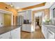 Kitchen with stainless steel refrigerator, white cabinets, and wood floors at 861 N Humboldt St # A, Denver, CO 80218