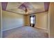 Primary bedroom featuring a unique ceiling design, ceiling fan, and plush carpeting at 7243 S Millbrook Ct # F, Aurora, CO 80016