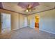 Spacious Primary bedroom with plush carpeting, adjacent bathroom, and walk in closet at 7243 S Millbrook Ct # F, Aurora, CO 80016