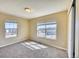 Sunlit bedroom with carpeted floors and two windows offering serene neighborhood views at 7243 S Millbrook Ct # F, Aurora, CO 80016