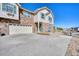 A charming townhome featuring a stone facade and a spacious two-car garage at 7243 S Millbrook Ct # F, Aurora, CO 80016