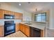 Well-equipped kitchen featuring sleek appliances, wood cabinets, and counter seating at 7243 S Millbrook Ct # F, Aurora, CO 80016