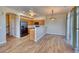 Open-concept kitchen with stainless steel appliances and wood floors at 7243 S Millbrook Ct # F, Aurora, CO 80016