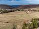 Aerial view of property in valley with mountain range and city skyline in the distance at 2 Twin Flower, Littleton, CO 80127