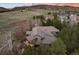 Scenic aerial view showcases home with fire pit, lush greenery and mountain views at 2 Twin Flower, Littleton, CO 80127