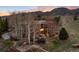 Gorgeous aerial view of home with outdoor deck, patio, outdoor fireplace, and mountain views at 2 Twin Flower, Littleton, CO 80127