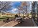 Outdoor dining set on the wooden deck, overlooks green space and mature trees at 2 Twin Flower, Littleton, CO 80127