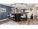 Stylish bar area with high stools, granite countertop, modern lighting, and a window to the adjacent room at 2 Twin Flower, Littleton, CO 80127