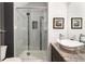 Modern bathroom featuring a glass-enclosed shower with decorative tile accents and granite countertop at 2 Twin Flower, Littleton, CO 80127