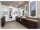 Elegant bathroom with dual sinks, dark wood cabinetry, and modern fixtures and tile floor at 2 Twin Flower, Littleton, CO 80127