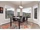 Cozy breakfast nook with views of the outdoors, a modern chandelier, and neutral decor at 2 Twin Flower, Littleton, CO 80127