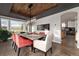 Stylish dining room with wood beam ceiling, modern chandelier and large windows with natural light at 2 Twin Flower, Littleton, CO 80127