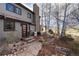 Picturesque home exterior with stone pathway, mature trees and lush greenery at 2 Twin Flower, Littleton, CO 80127