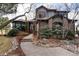 Charming home featuring lush landscaping, brick and siding, and inviting entryway at 2 Twin Flower, Littleton, CO 80127