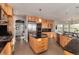 Spacious kitchen featuring custom wood cabinets, stainless steel appliances, and granite countertops at 2 Twin Flower, Littleton, CO 80127