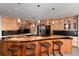 Modern kitchen with custom wood cabinetry, stainless appliances, and a breakfast bar at 2 Twin Flower, Littleton, CO 80127