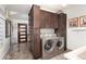 Laundry room with full-size washer and dryer, tile floors and storage cabinets at 2 Twin Flower, Littleton, CO 80127