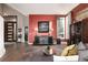 Inviting living room featuring a striking red wall, modern decor, and abundant natural light at 2 Twin Flower, Littleton, CO 80127