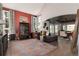 Open-concept living room with hardwood floors, display case and views into dining room at 2 Twin Flower, Littleton, CO 80127