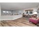 Spacious loft area with hardwood floors, plenty of natural light, and cozy seating near the bookcase at 2 Twin Flower, Littleton, CO 80127