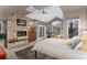 Tranquil main bedroom with a stone fireplace, sitting area, and access to natural light at 2 Twin Flower, Littleton, CO 80127
