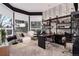 Stylish home office featuring a large desk, open shelving, and comfortable seating with lots of natural light at 2 Twin Flower, Littleton, CO 80127