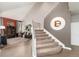 Elegant staircase adjacent to a cozy living area with stylish furnishings and neutral color palette at 2 Twin Flower, Littleton, CO 80127