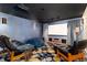 Cozy theater room with a projector screen, leather seating, unique lighting, and textured blue walls at 2 Twin Flower, Littleton, CO 80127