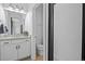 Modern bathroom with white vanity, updated fixtures, and glass-enclosed shower at 16202 W 95Th Ln, Arvada, CO 80007