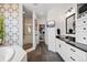 Stylish bathroom with a glass-enclosed shower, soaking tub, dual sinks, and modern finishes at 16202 W 95Th Ln, Arvada, CO 80007