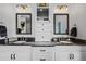 Modern bathroom with dual sinks, granite countertops, and stylish lighting and cabinetry at 16202 W 95Th Ln, Arvada, CO 80007